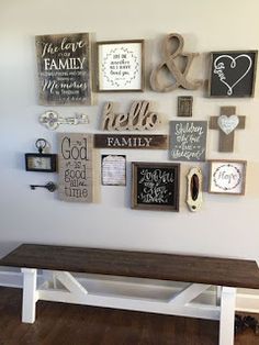 a wooden bench sitting in front of a wall with many different types of signs on it