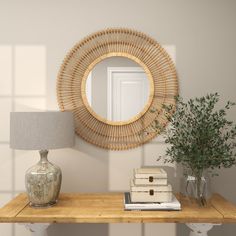 a wooden table topped with a lamp and a mirror