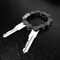 two keys that are sitting on top of each other in the shape of a chain