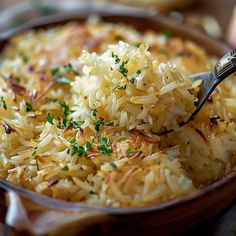 a bowl filled with rice and garnished with parsley