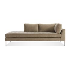 a beige couch sitting on top of a white floor