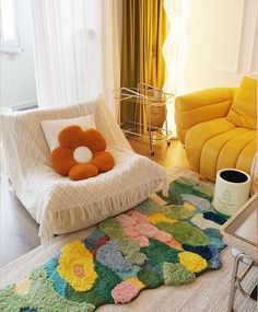 a living room with a couch, chair and rug on the floor in front of a window