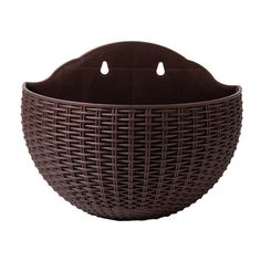 a brown wicker basket with two holes