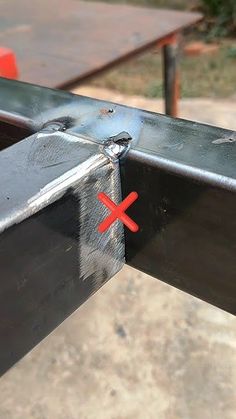 a piece of metal that has been placed on top of some kind of table with two red crosses