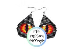 a pair of earrings with the words pop pattern earings