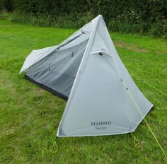 a tent pitched up in the grass