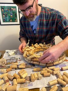 a man is making wine corks on a table