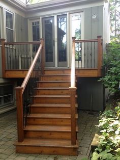 a house with stairs leading to the front door