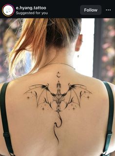 the back of a woman's shoulder with a tattoo on it, and an image of a dragon