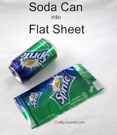 two soda cans sitting next to each other on top of a white sheet with the words, soda can into flat sheet