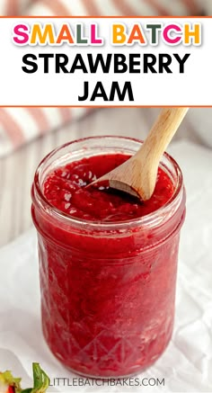 small batch strawberry jam in a jar with a wooden spoon