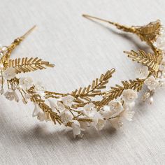 a gold and white headpiece with flowers on it