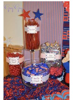 candy bar with red, white and blue candies in glass bowls on table cloth