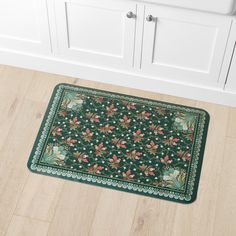 a green rug with red flowers on it