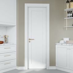 an open door in a kitchen with white cabinets