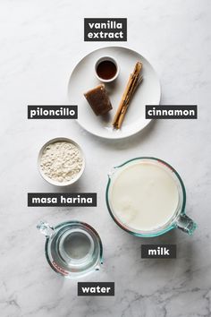 ingredients to make vanilla milk on a marble counter top