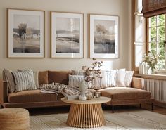 a living room filled with furniture and pictures hanging on the wall above a coffee table