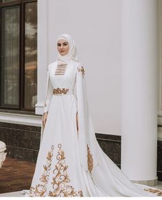 a woman in a white and gold wedding gown