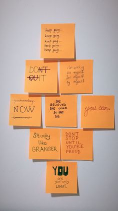 several sticky notes attached to a wall with words written on them, all pinned together