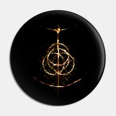 a black and gold design on a round button with light streaks in the middle,