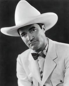 a man wearing a white suit and hat