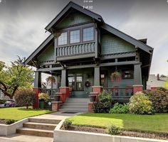 a house with green siding and red trim