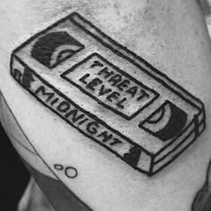 a black and white photo of a man's arm with a tattoo on it