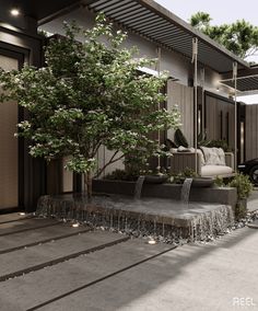 an outdoor living area with trees, couches and water running down the side of it