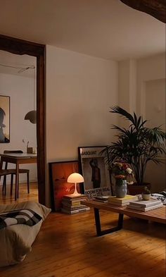 a living room filled with furniture and a lamp on top of a wooden table in front of a window