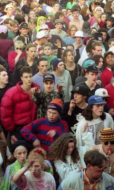 a crowd of people standing next to each other