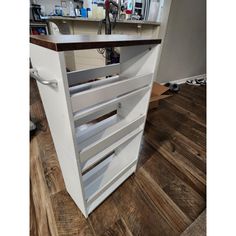 a kitchen island made out of drawers in the middle of a room