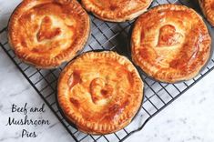 four baked pies sitting on top of a cooling rack next to each other with the words bee and mushroom pie written in it