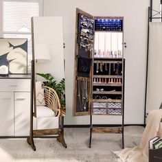 an open cabinet with many items on it in a living room next to a chair