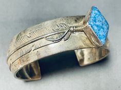 MAKE US AN OFFER BY CLICKING THE "MESSAGE SELLER" Button- This is a fabulous vintage Navajo diamond shaped lapis stone silver cuff bracelet. This remarkable bracelet contains a stunning offset diamond shaped denim lapis stone. Running down both ends of the cuff are marvelous silver works that consist of a long detailed silver feather with accenting silver diamond and sun stampings. The detailing is just phenomenal. I absolutely love how thick and sturdy this bracelet is.  The center stone measur Lapis Stone, Silver Feather, Vintage Navajo, Diamond Shaped, Silver Cuff Bracelet, Sterling Silver Bracelet, Silver Cuff, Silver Diamonds, Sterling Silver Bracelets