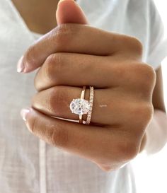 a woman's hand with a ring on it and a diamond in the middle