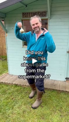 a man standing in front of a blue house with his arm up and the caption did you know about garlic from the super market?