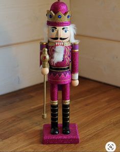 a nutcracker is standing on a wooden floor