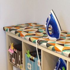 an ironing board sitting on top of a wooden shelf