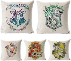 four harry potter pillows with hogwart's crests on them