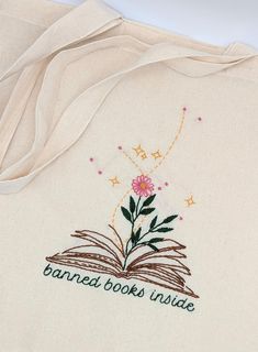 an embroidered book cover with a flower on it and the words banca books inside