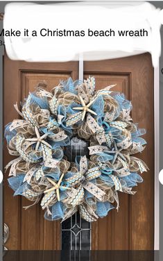 a blue and white wreath on the front door with starfishs hanging from it