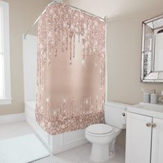 a bathroom with a pink shower curtain and white toilet