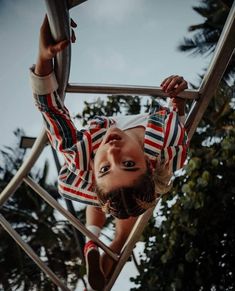 a girl climbing up a metal ladder in an instagram with the caption'purusuto portraits follow '