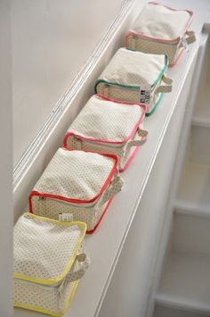 five bags lined up in a row on the side of a white refrigerator freezer