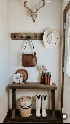 there is a shelf with hats and other items on it in the entryway area