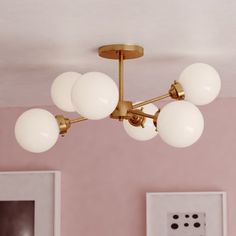 a chandelier hanging from the ceiling in a pink room