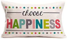 a white pillow with the words choose happiness printed in multicolored letters on it