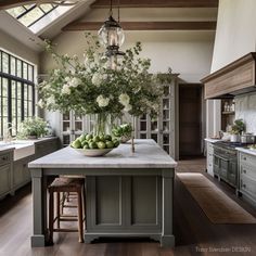 a large kitchen island topped with lots of green fruit and vegtables on top of it