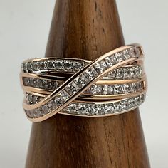 a diamond ring on top of a wooden stand