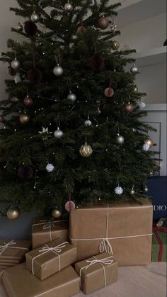 a christmas tree with presents under it